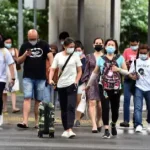 Singapore advises wearing masks amid sharp rise in COVID cases